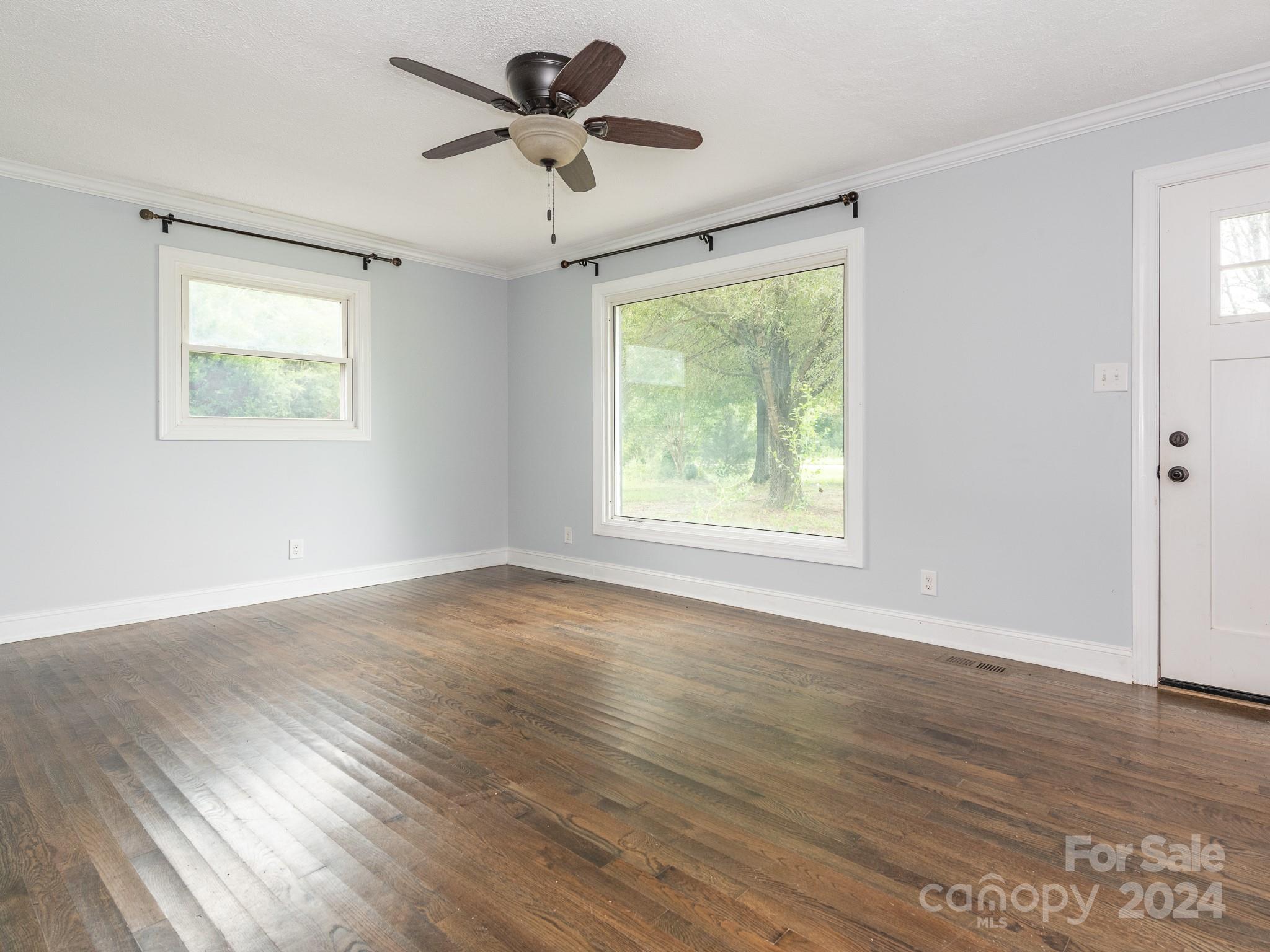 8106 Indian Trail Fairview Road Indian Trail, NC 28079 - Photo 4 of 17 a view of an empty room with wooden floor and a window