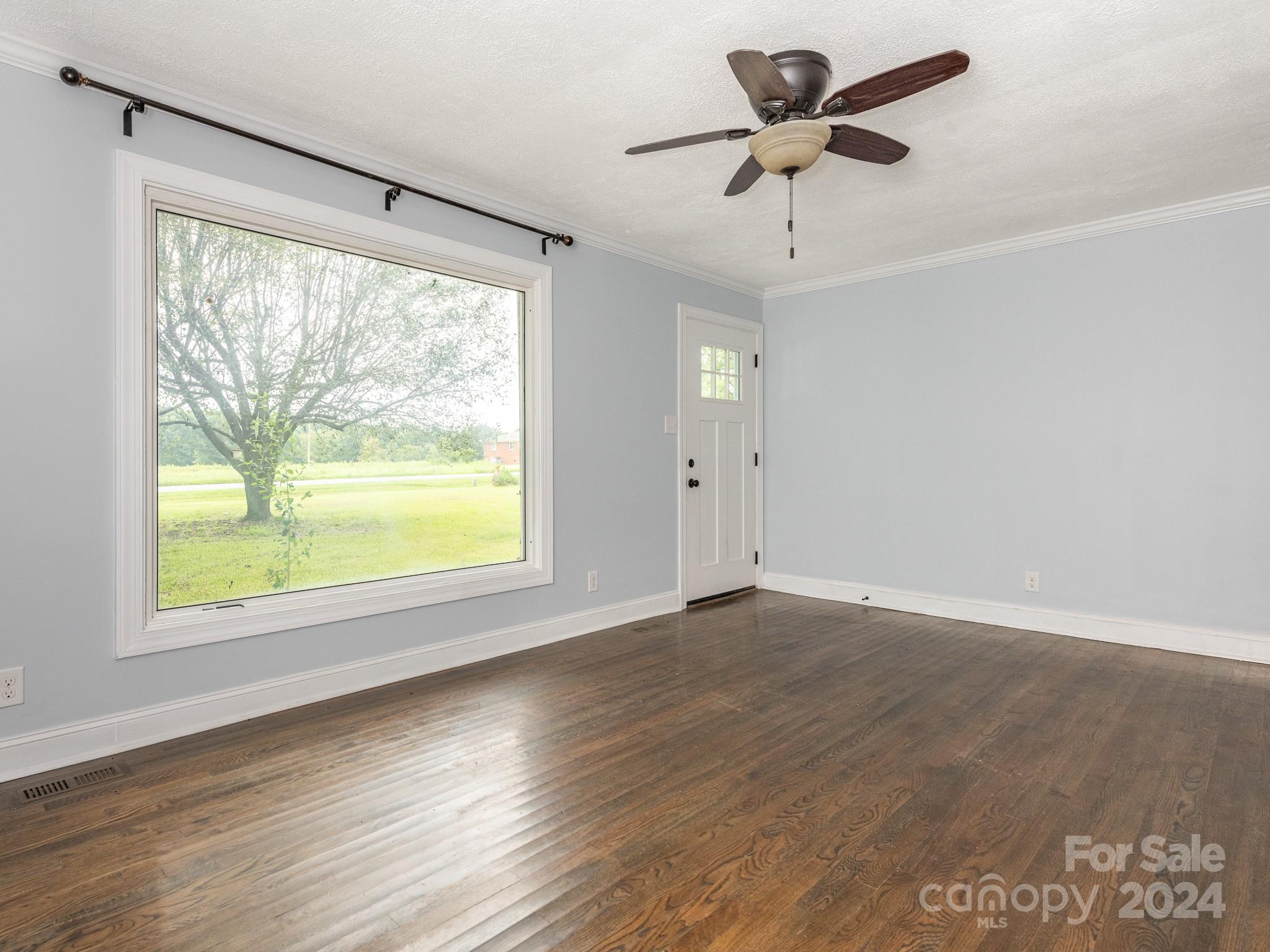 8106 Indian Trail Fairview Road Indian Trail, NC 28079 - Photo 5 of 17 a view of an empty room with wooden floor and a window