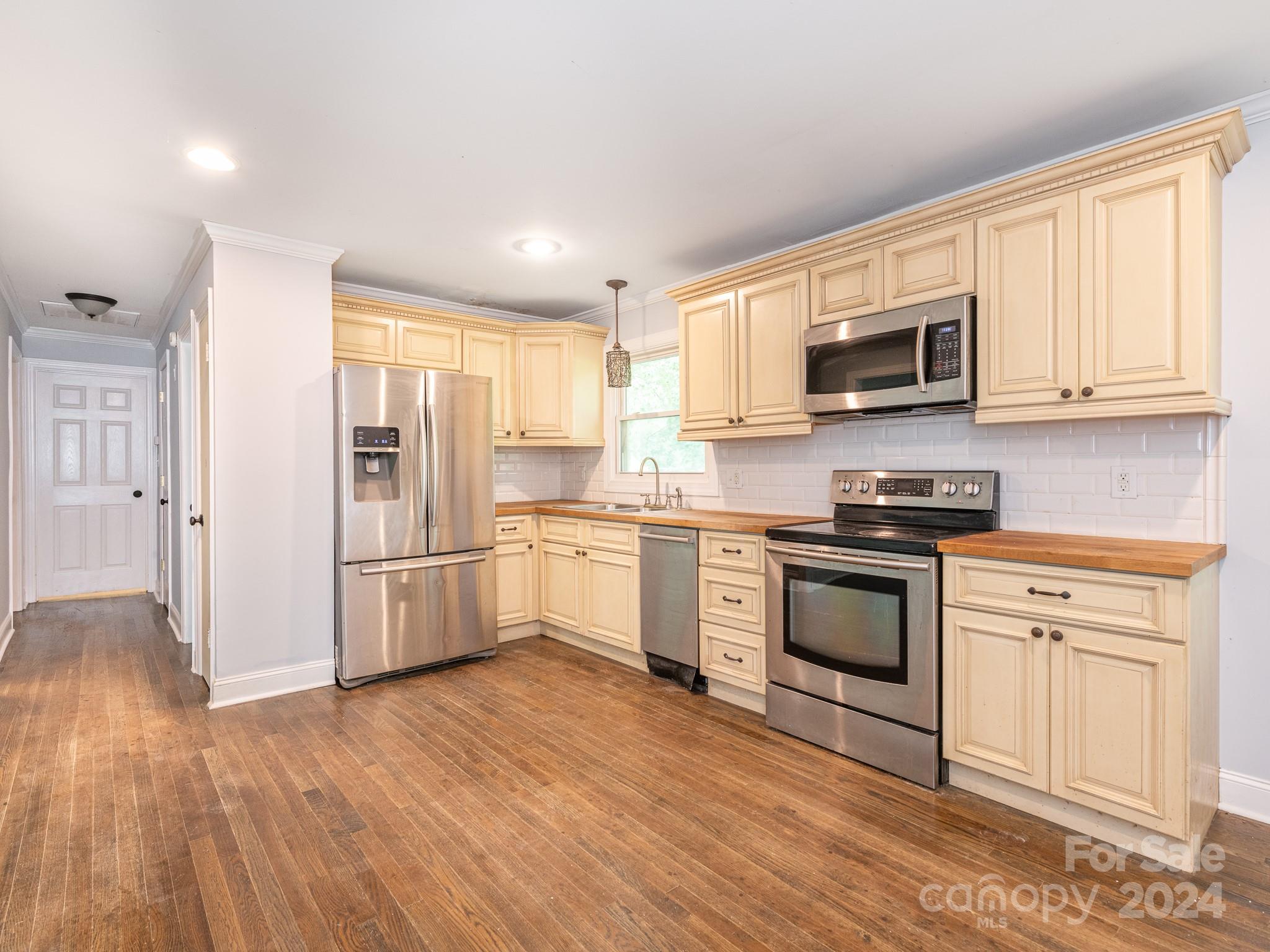 8106 Indian Trail Fairview Road Indian Trail, NC 28079 - Photo 6 of 17 a kitchen with granite countertop white cabinets and stainless steel appliances