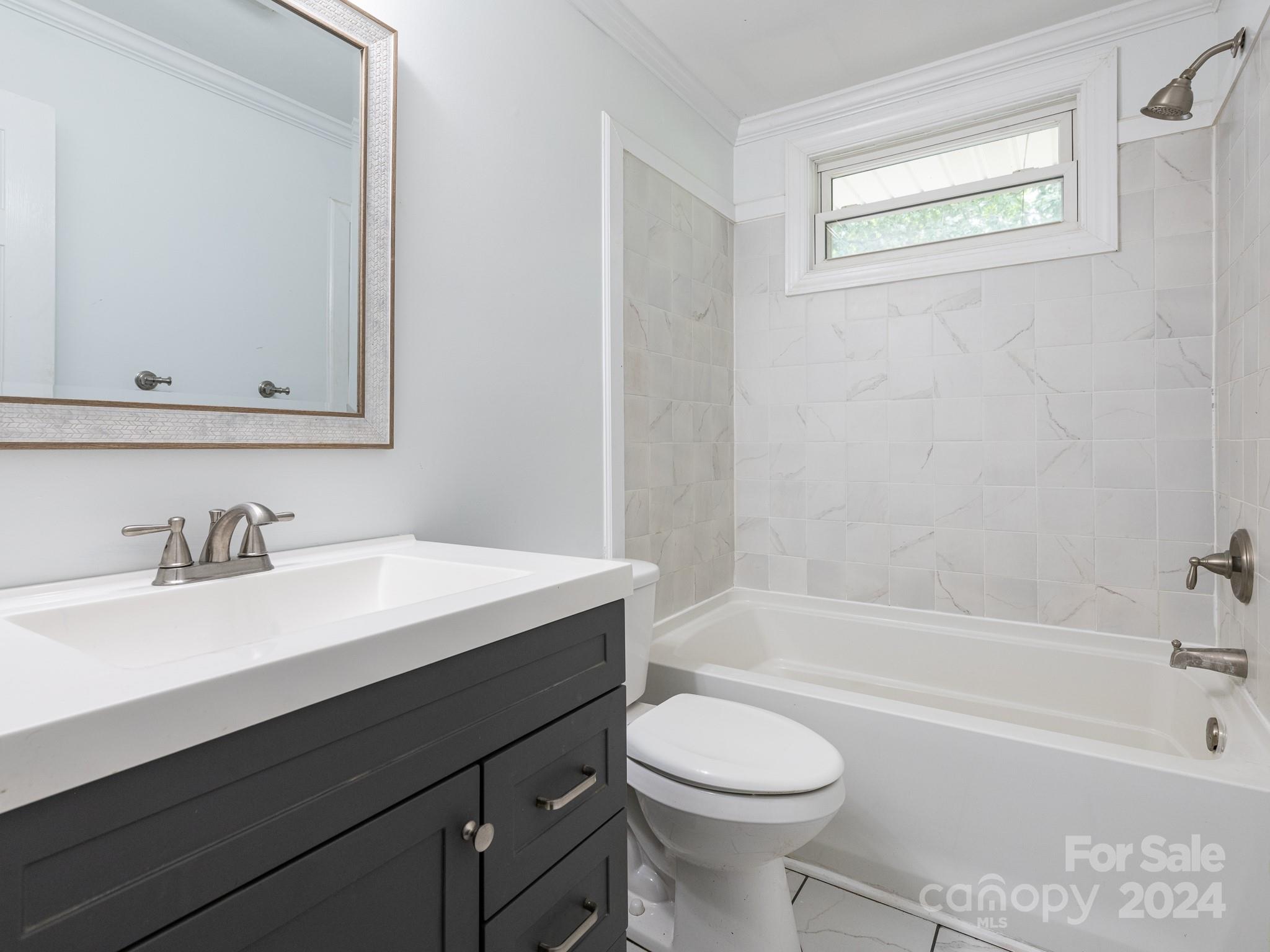 8106 Indian Trail Fairview Road Indian Trail, NC 28079 - Photo 8 of 17 a bathroom with a bathtub sink vanity mirror and toilet