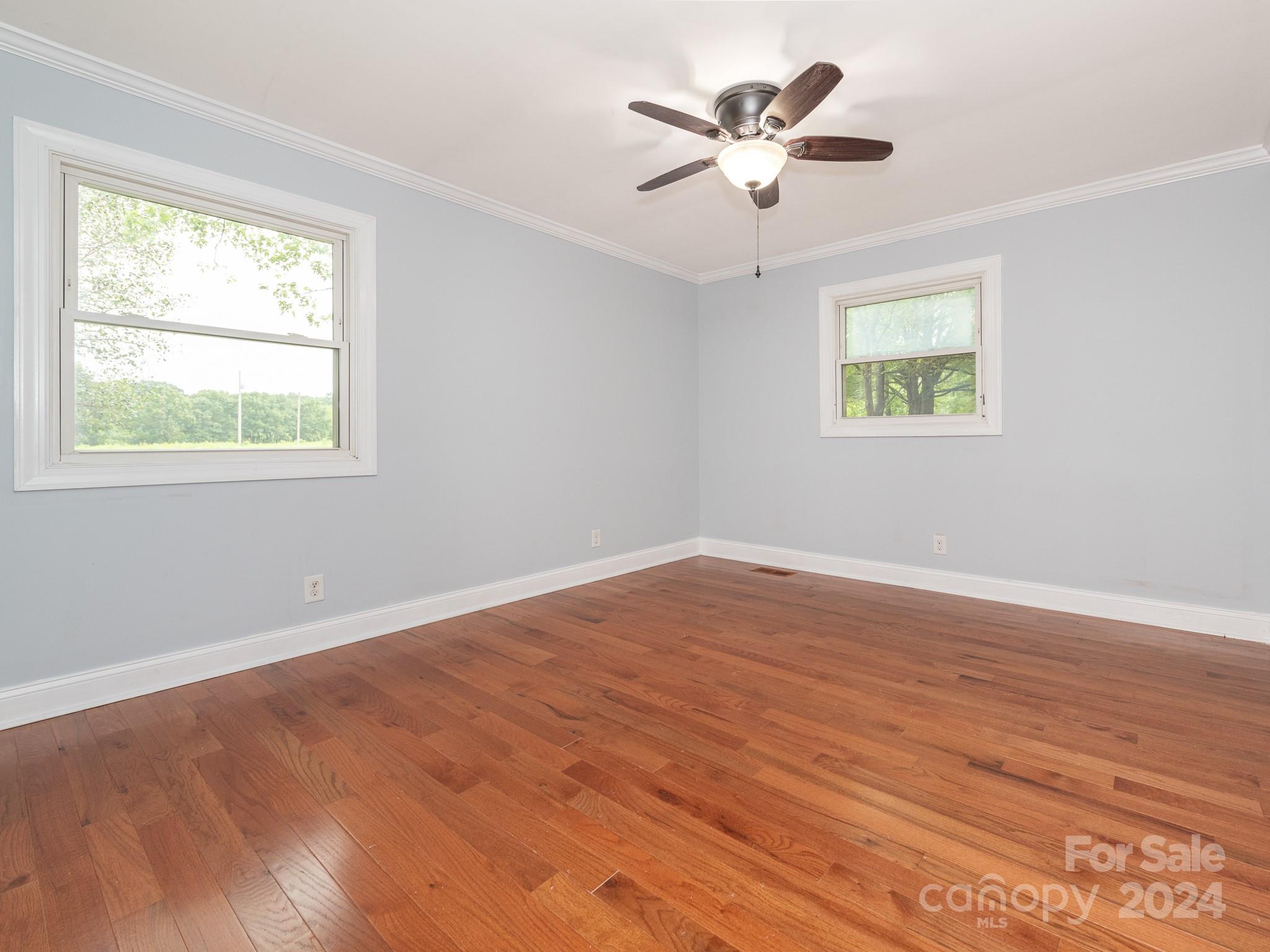 8106 Indian Trail Fairview Road Indian Trail, NC 28079 - Photo 10 of 17 a view of an empty room with wooden floor and a window