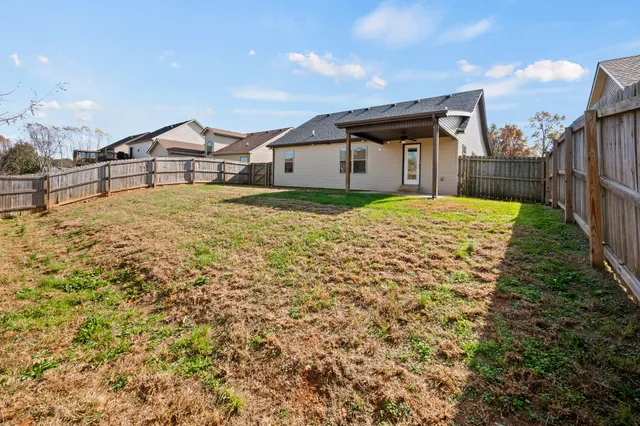 a house view with a wooden fence