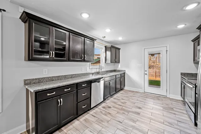 a kitchen with stainless steel appliances granite countertop a stove and a sink