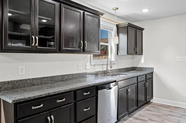 a kitchen with granite countertop stainless steel appliances and cabinets