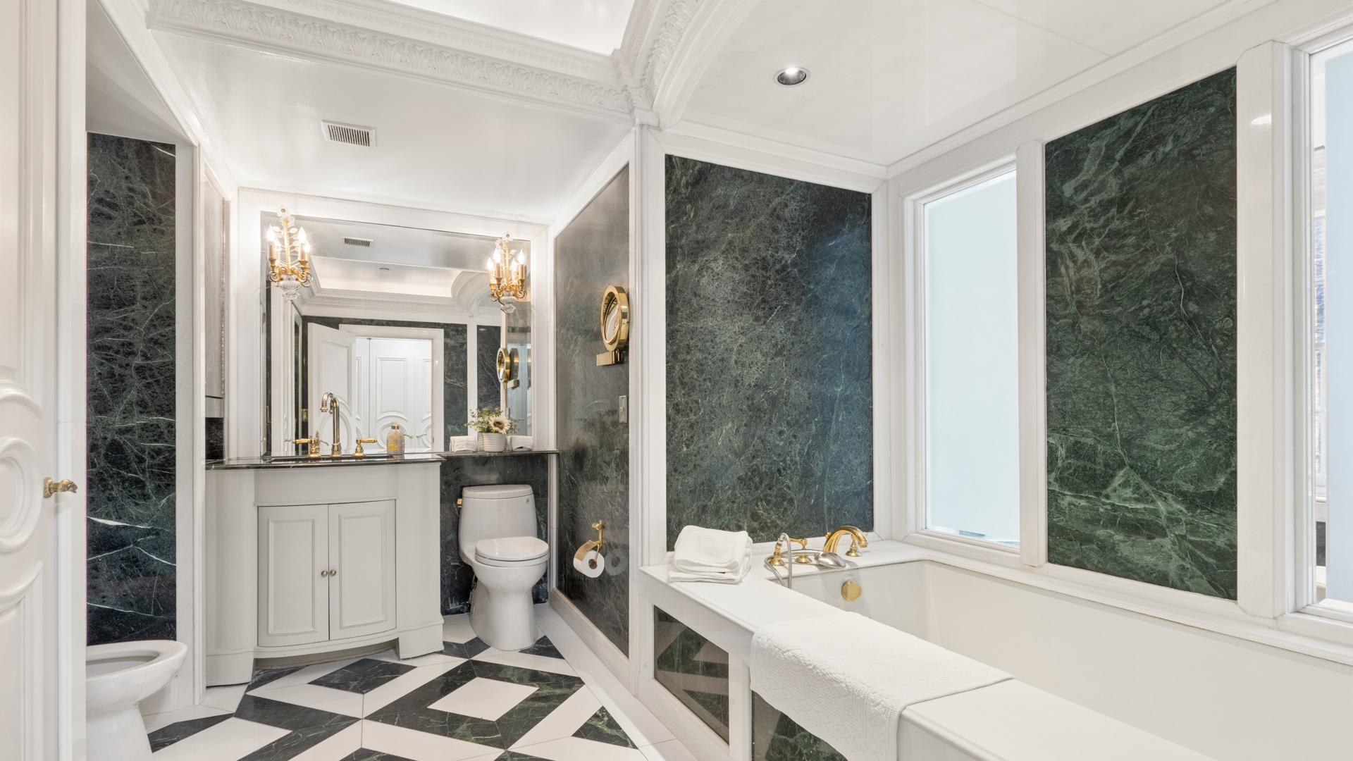 7 East 69th Street Manhattan, NY 10021 - Photo 13 of 27 a bathroom with a bathtub sink and toilet