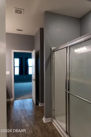 a view of gallery with wooden floor