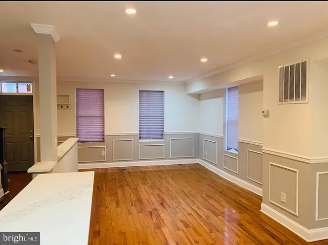 a view of a kitchen with a sink and a refrigerator