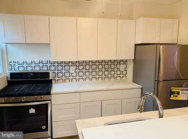 a kitchen with a sink cabinets and appliances