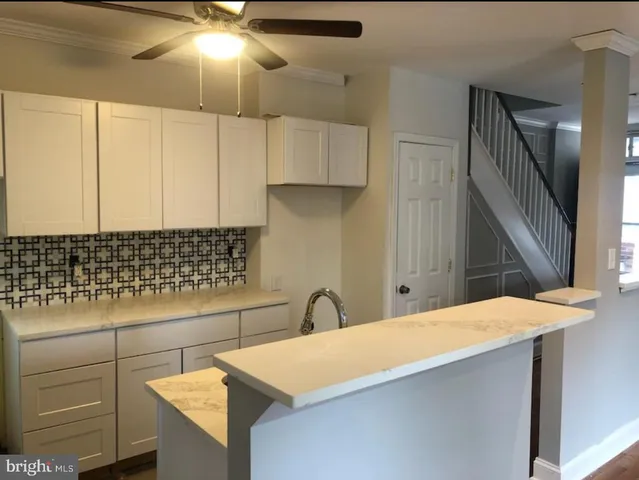 a kitchen with a sink cabinets and appliances