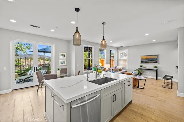 a kitchen with stainless steel appliances granite countertop a stove and a wooden floors