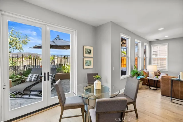 a view of a dining room with furniture large windows and wooden floor