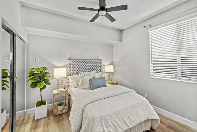 a bedroom with a bed potted plant and a window