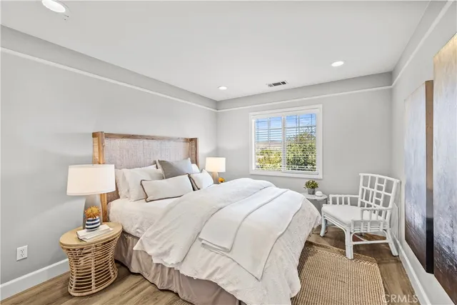 a bedroom with a bed and a lamp