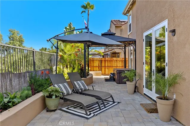 a view of a patio with table and chairs potted plants
