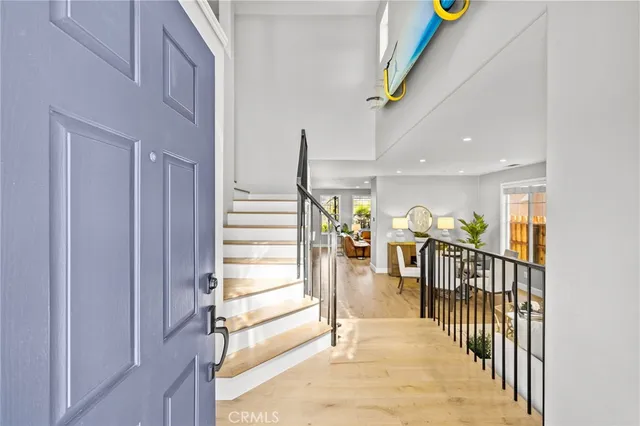 a view of staircase with lots of frames and flower plants