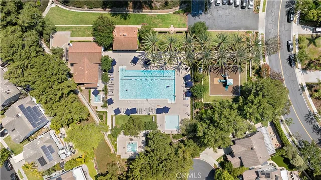 an aerial view of a house with a yard swimming pool