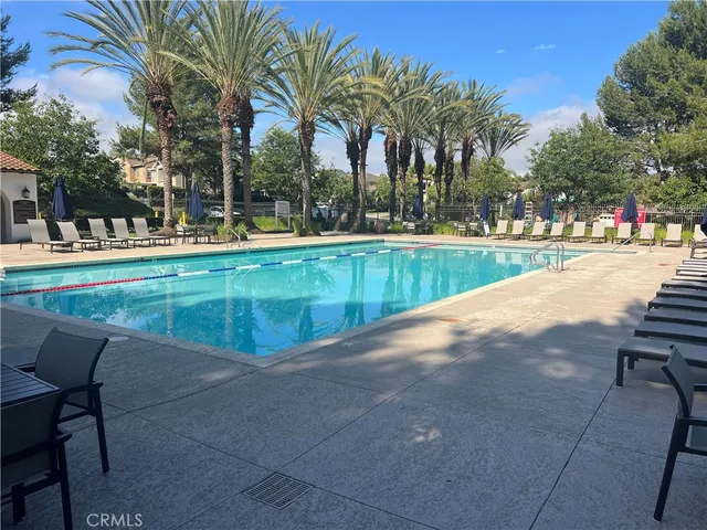 a view of swimming pool with outdoor seating and plants