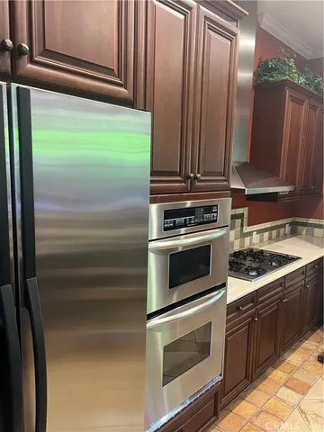 a kitchen with granite countertop a stove and a microwave