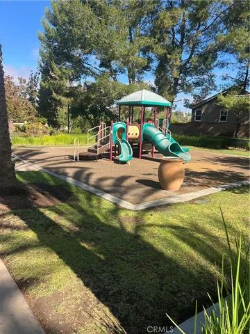 a view of a swimming pool with a table and chairs under an umbrella