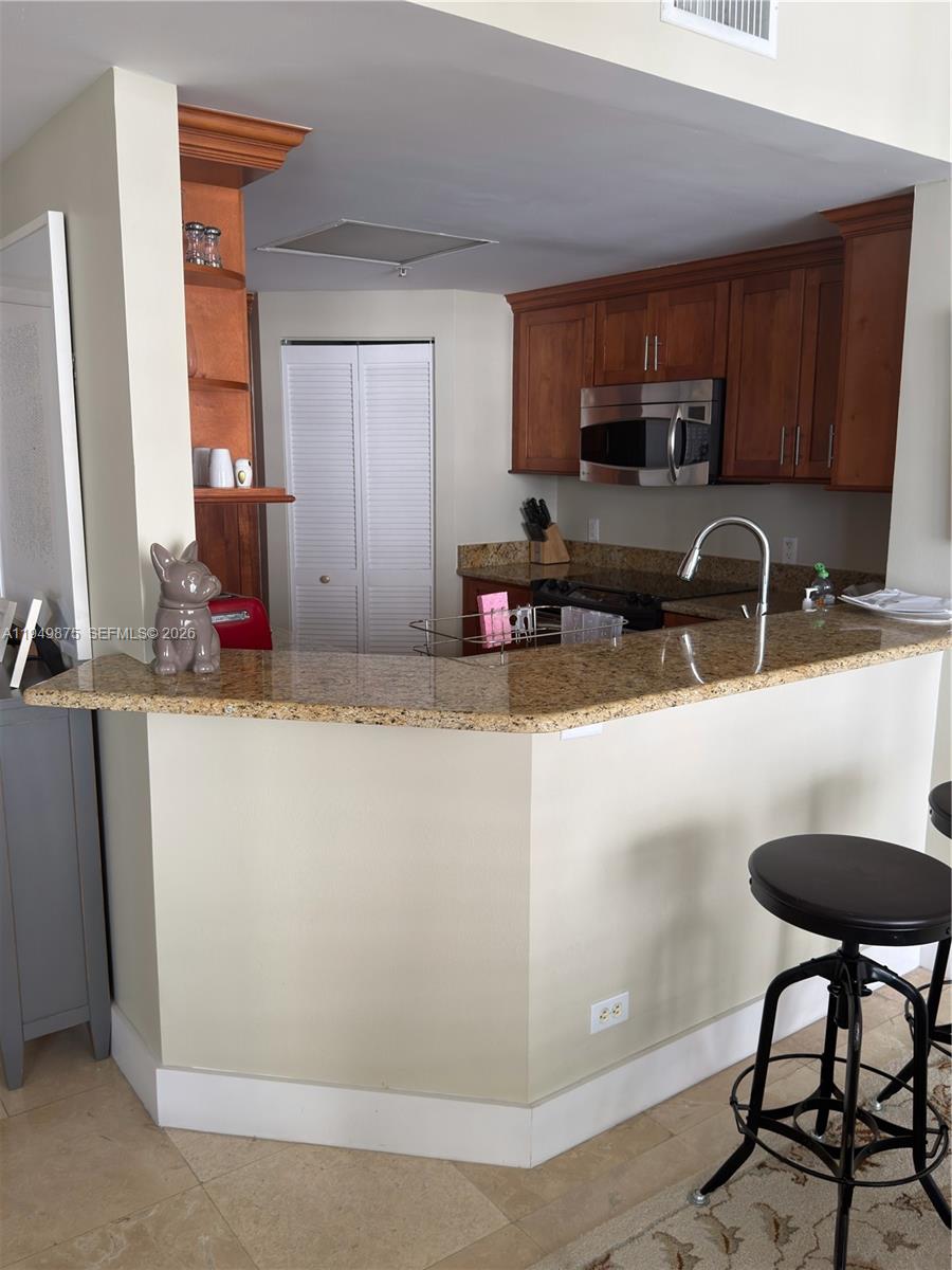 701 Brickell Key Boulevard, Unit PH08 Miami, FL 33131 - Photo 6 of 7 a kitchen with a sink a stove and cabinets