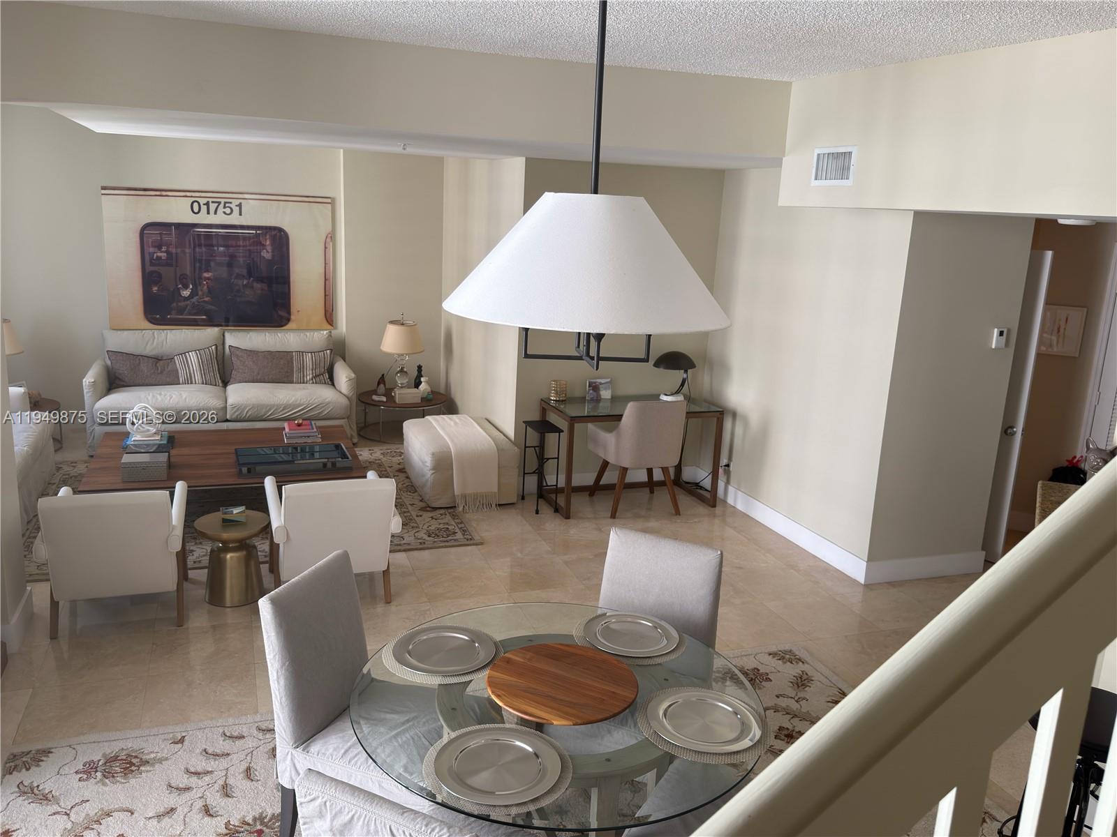 701 Brickell Key Boulevard, Unit PH08 Miami, FL 33131 - Photo 7 of 7 a living room with furniture and a window