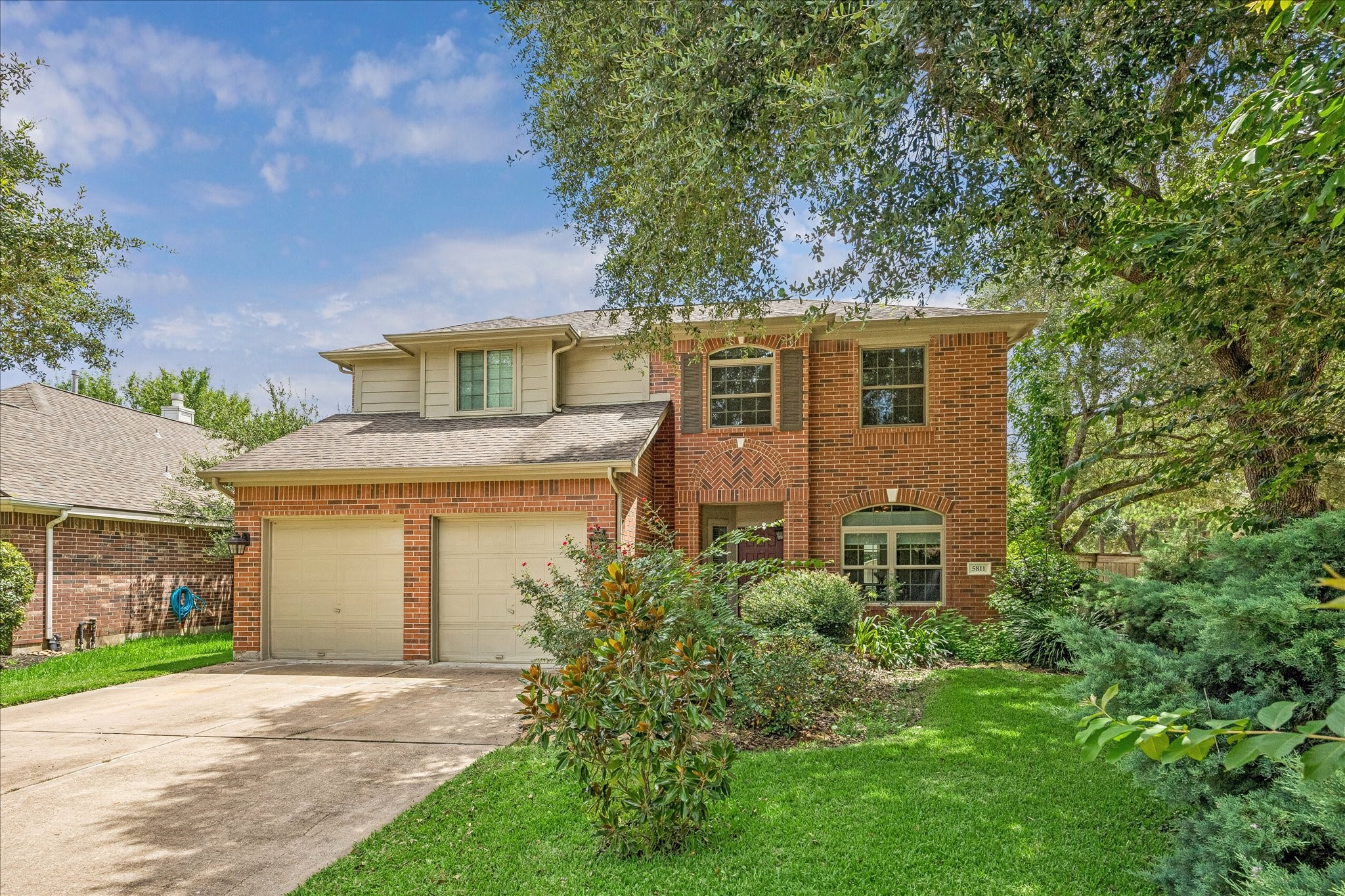 5811 Walkabout Way Katy, TX 77450 - Photo 1 of 33 Classic two-story brick home nestled beneath mature shade trees, offering timeless curb appeal and a welcoming presence from the moment you arrive.