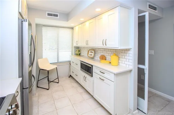 a kitchen with stainless steel appliances granite countertop a stove and a refrigerator