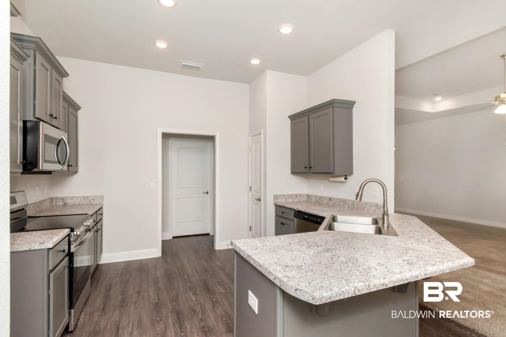 6632 Monarch Circle Mobile, AL 36618 - Photo 12 of 32 Kitchen featuring gray cabinetry, stainless steel appliances, a kitchen breakfast bar, a peninsula, and recessed lighting