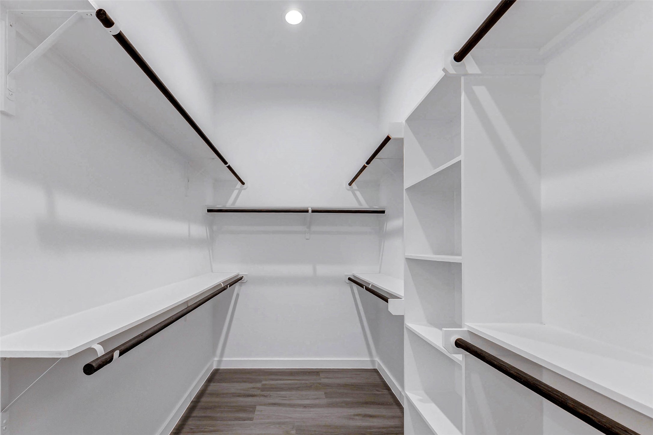 6017 Beall Street Houston, TX 77091 - Photo 19 of 33 A true walk-in dream closet with double hanging rods, open shelving, and built-in organization. Clean lines and generous dimensions ensure everything has its place.