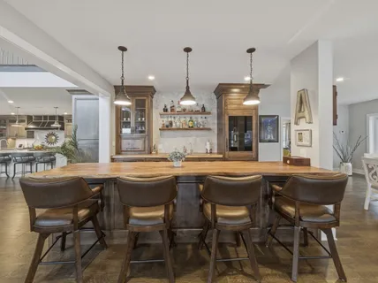 a view of a livingroom with furniture hardwood floor and a ceiling fan