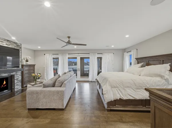 a bedroom with a bed and a ceiling fan