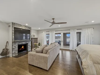 a bedroom with a bed and a ceiling fan