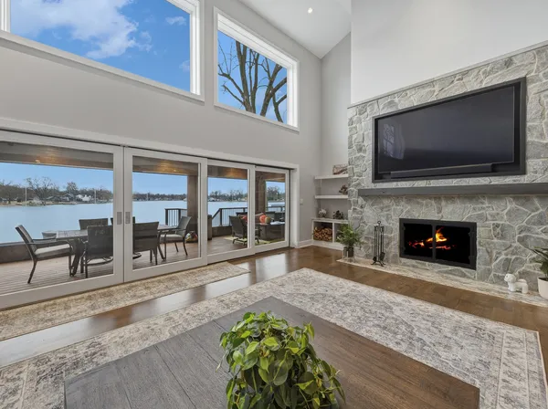 a living room with furniture a fireplace and a flat screen tv