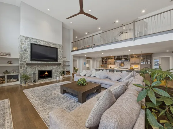 a open kitchen with stainless steel appliances granite countertop a table and chairs