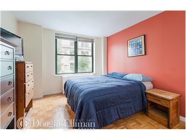 a bedroom with a bed and a tv