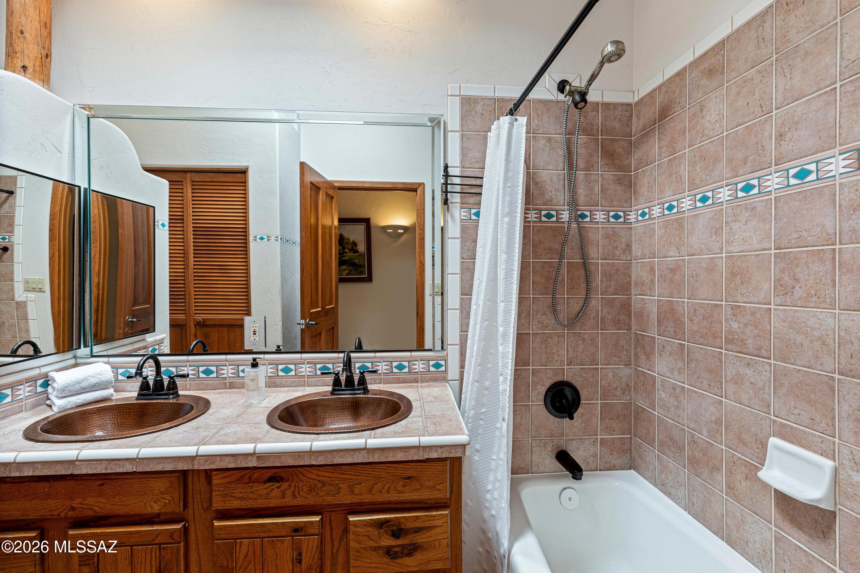 11160 East Golf Links Road Tucson, AZ 85730 - Photo 26 of 51 Full guest bathroom with double copper sinks and a linen closet.