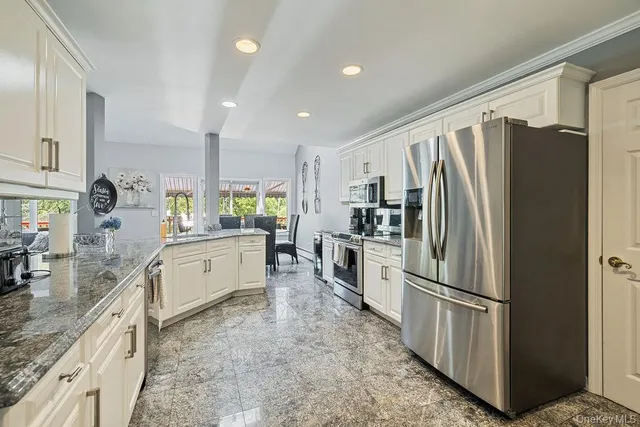 a kitchen with refrigerator and cabinets
