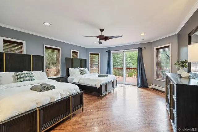 a spacious bedroom with a large bed and a chandelier