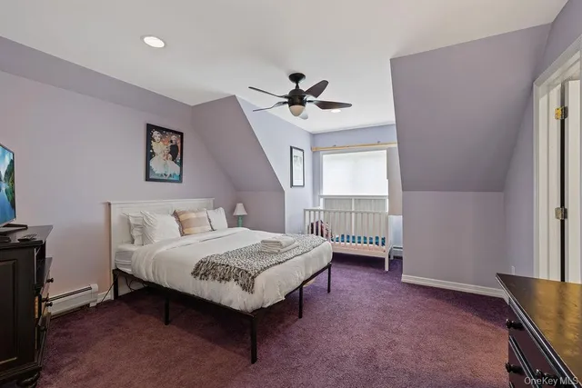 a spacious bedroom with a bed and a ceiling fan