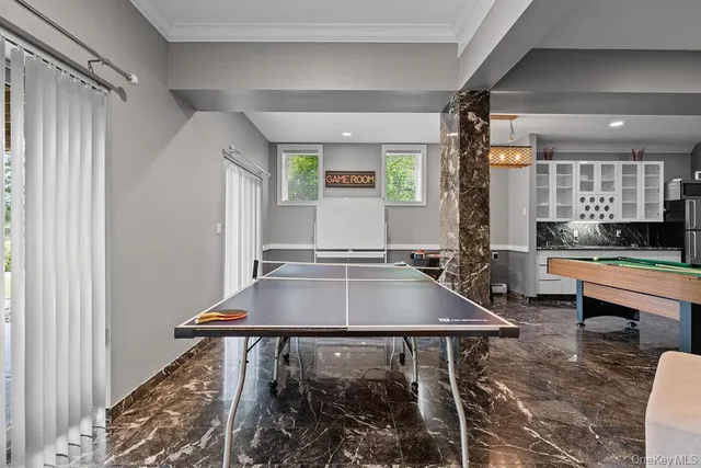 a kitchen with a table chairs a stove and a window