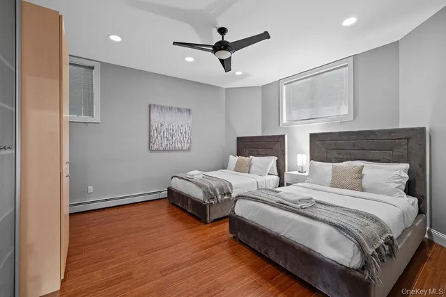 a spacious bedroom with a bed and a ceiling fan