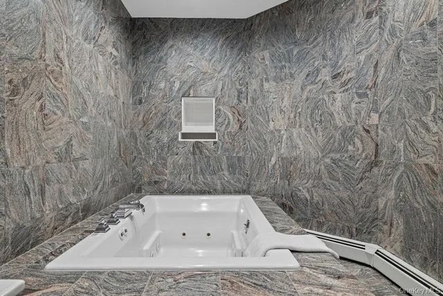 a bathroom with a bathtub and shower