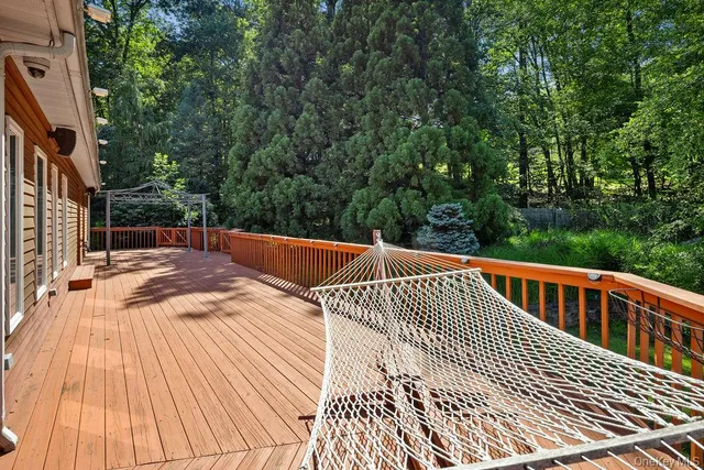 a view of balcony with wooden floor and fence
