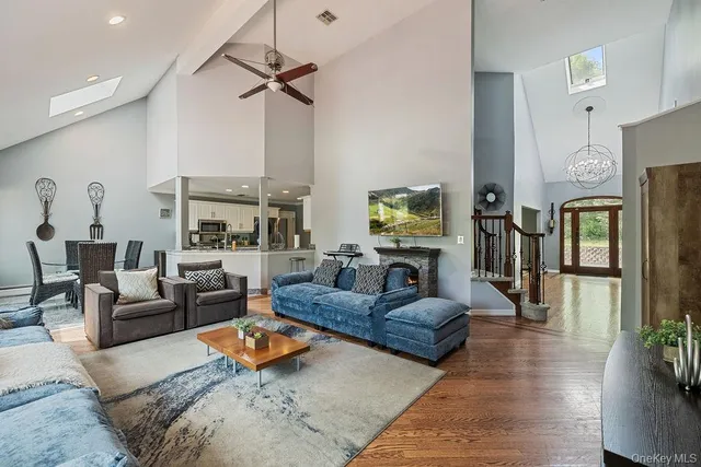 a living room with furniture fireplace and a window