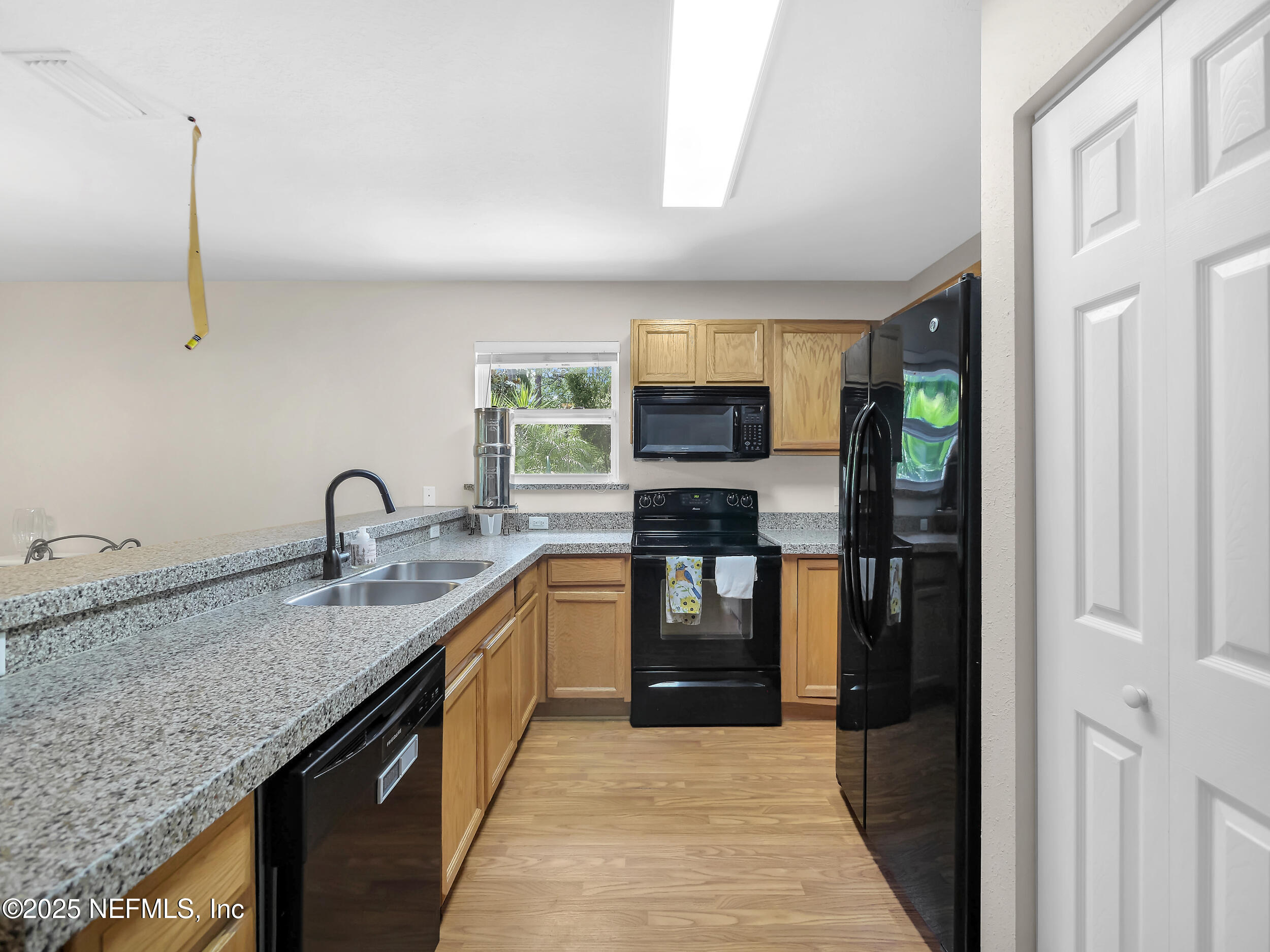 1193 4 Mile Road St. Augustine, FL 32084 - Photo 18 of 54 a kitchen with kitchen island granite countertop a sink appliances and cabinets