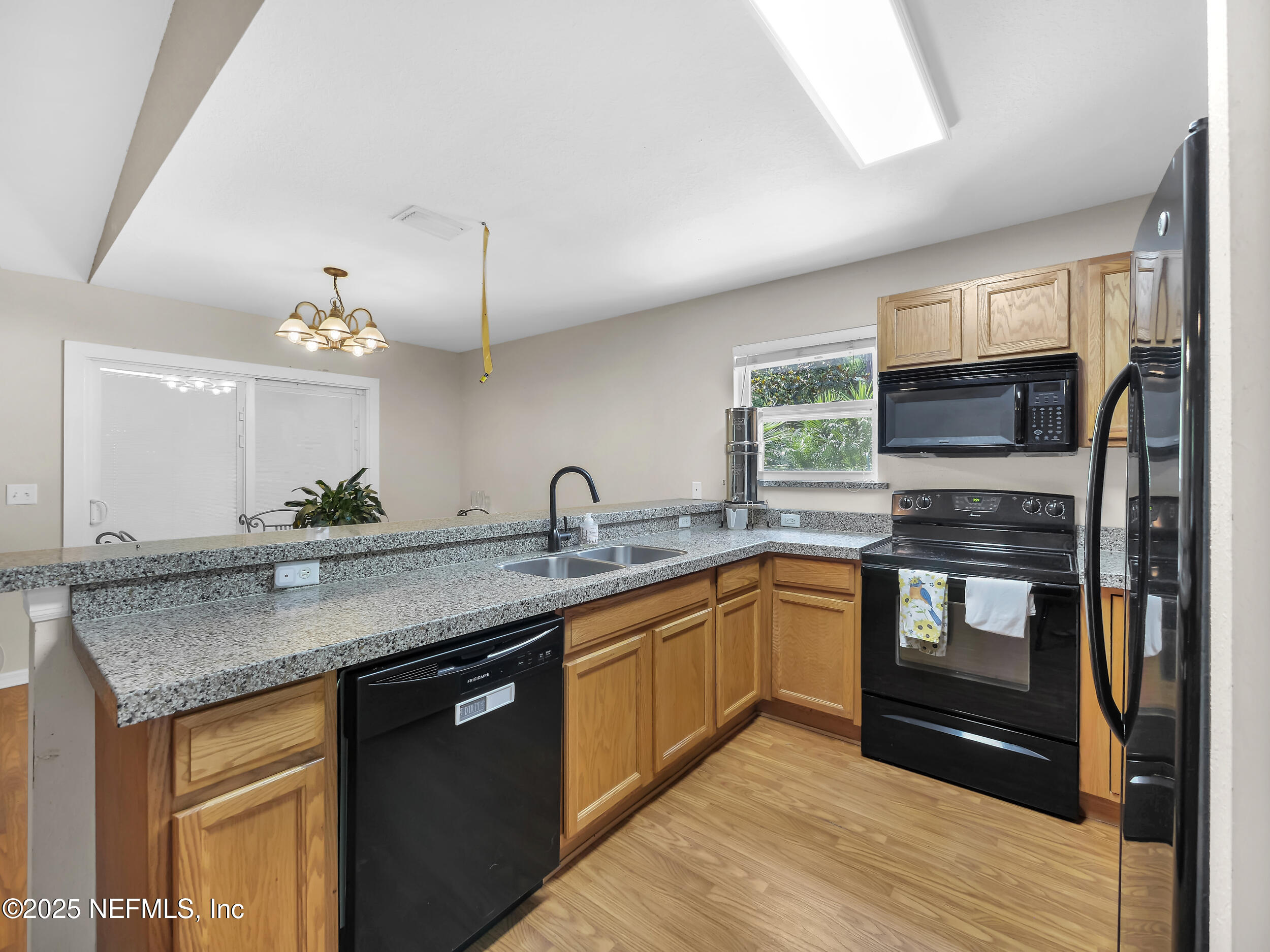 1193 4 Mile Road St. Augustine, FL 32084 - Photo 19 of 54 a kitchen with stainless steel appliances granite countertop a sink stove and cabinets