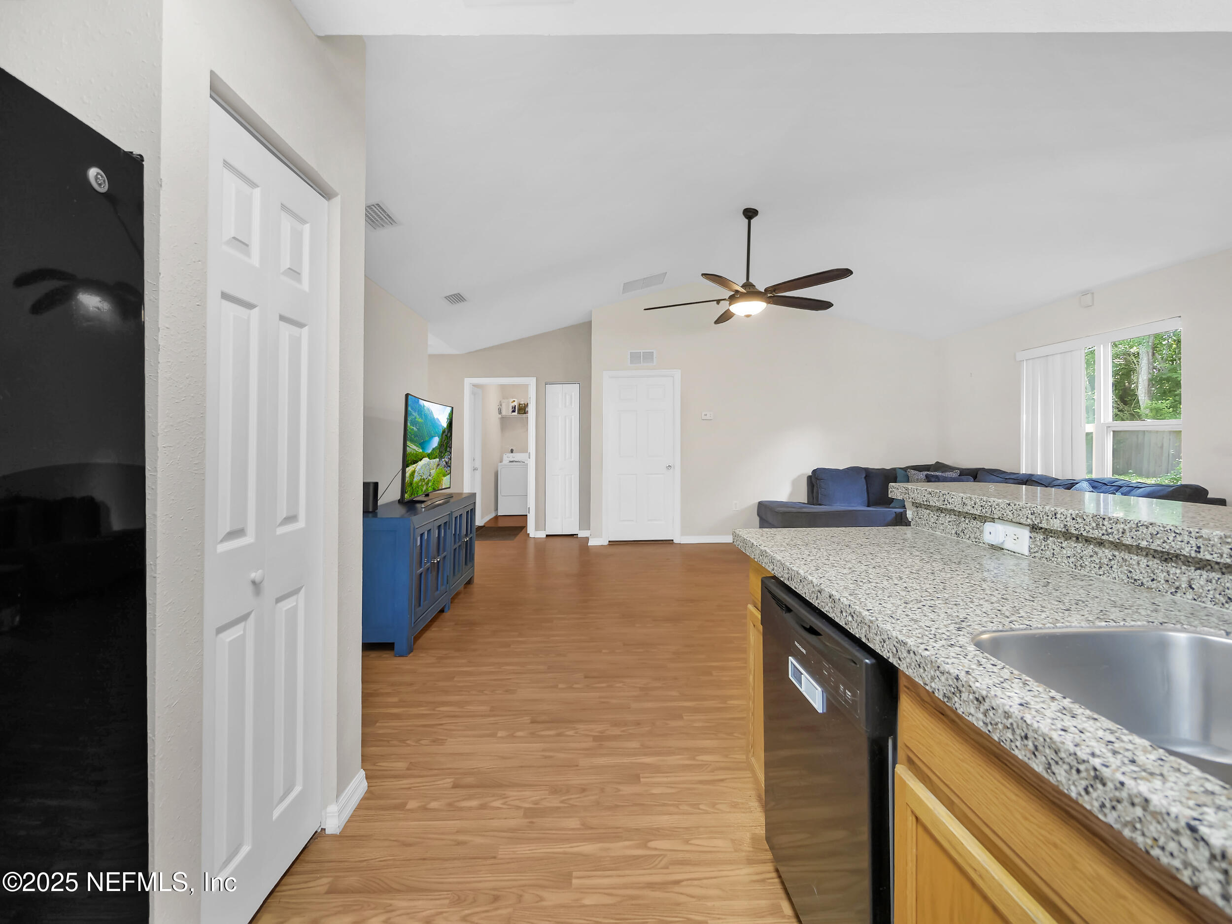1193 4 Mile Road St. Augustine, FL 32084 - Photo 20 of 54 a kitchen with a sink refrigerator and cabinets