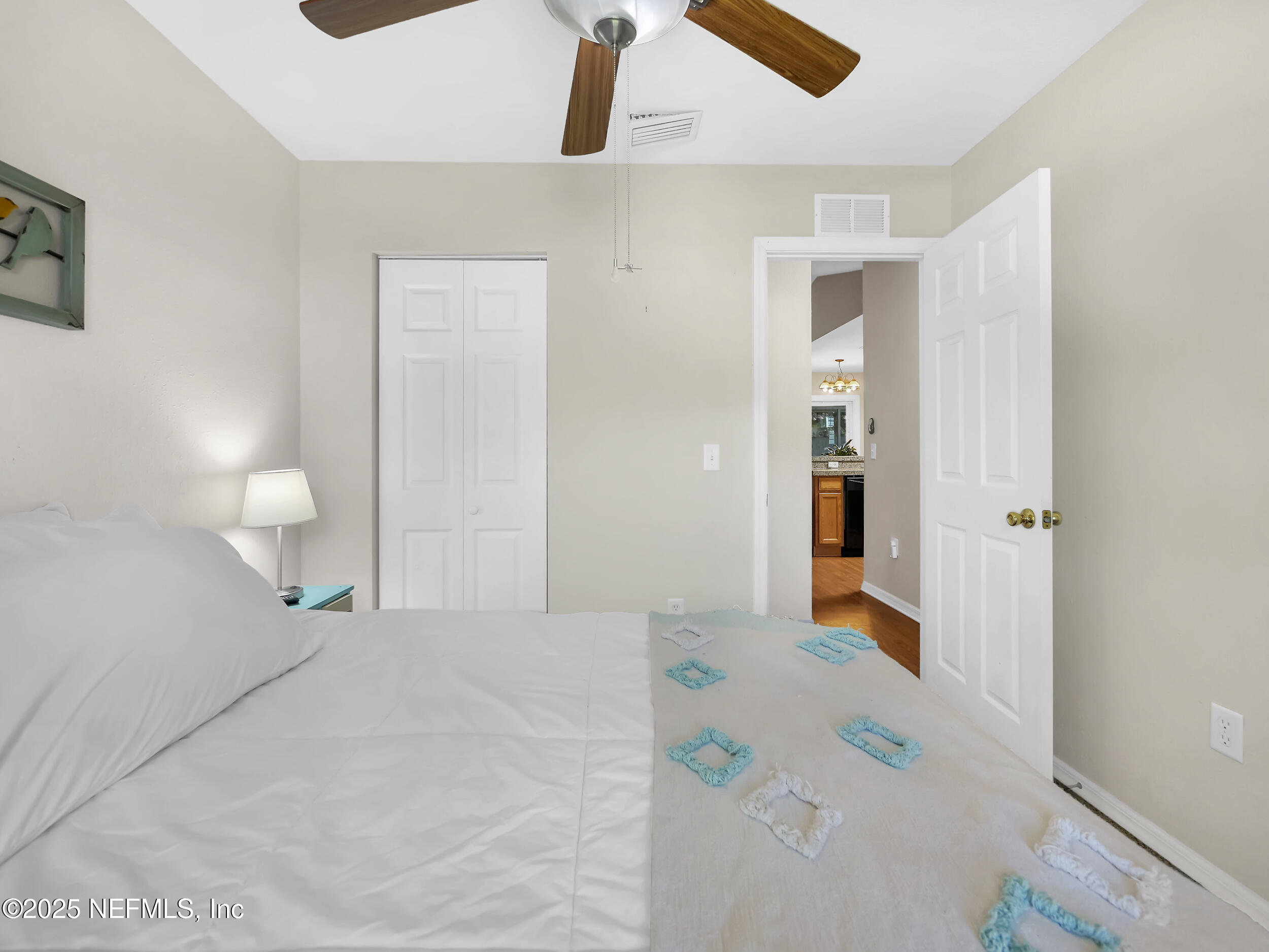 1193 4 Mile Road St. Augustine, FL 32084 - Photo 26 of 54 a bedroom with a bed and a chandelier