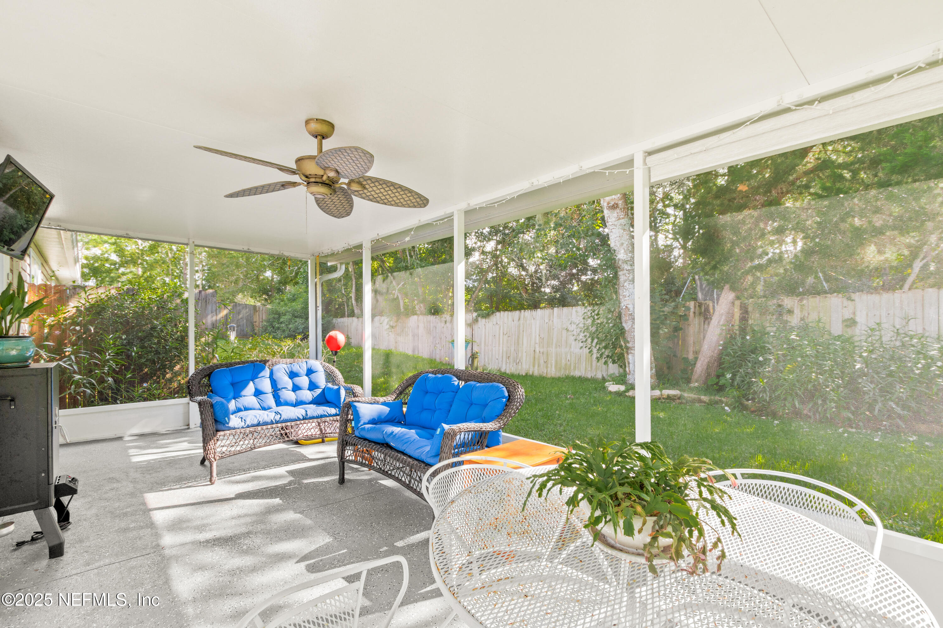 1193 4 Mile Road St. Augustine, FL 32084 - Photo 28 of 54 a living room with patio furniture and a floor to ceiling window