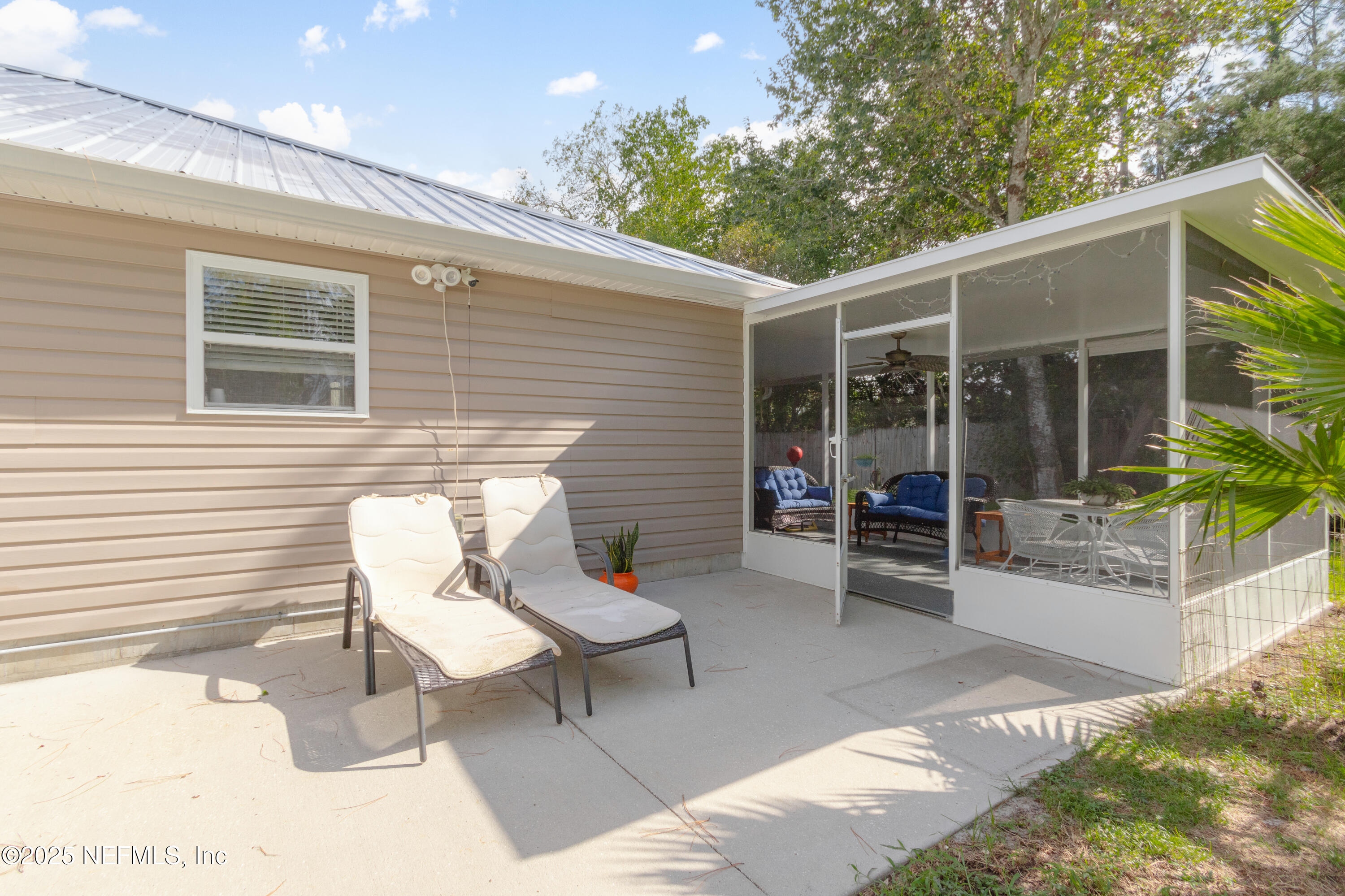 1193 4 Mile Road St. Augustine, FL 32084 - Photo 29 of 54 a view of a patio with table and chairs with wooden floor and fence